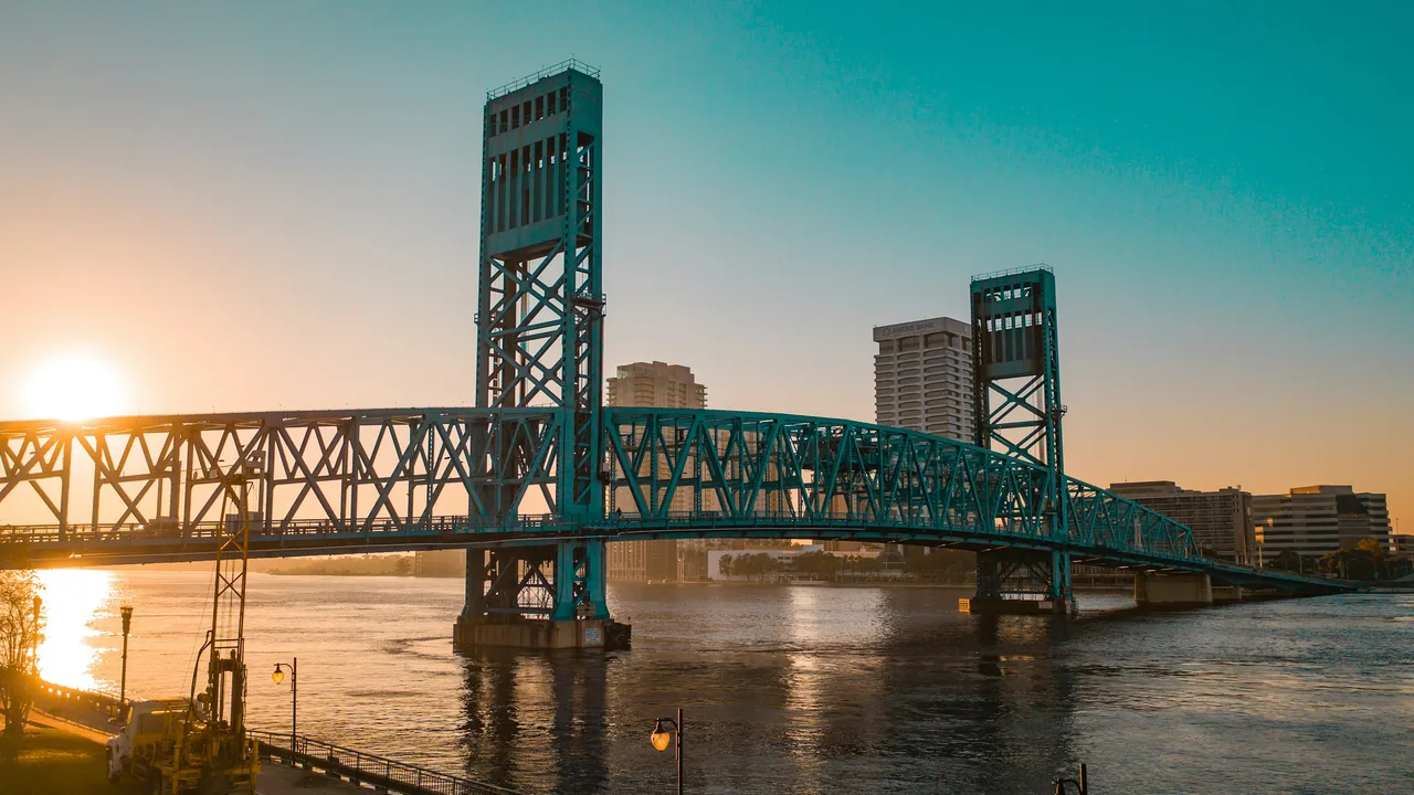 Green steel bridge over the St. Johns River in Jacksonville, Florida; regional orientation, not a photo of each locality or a roof project