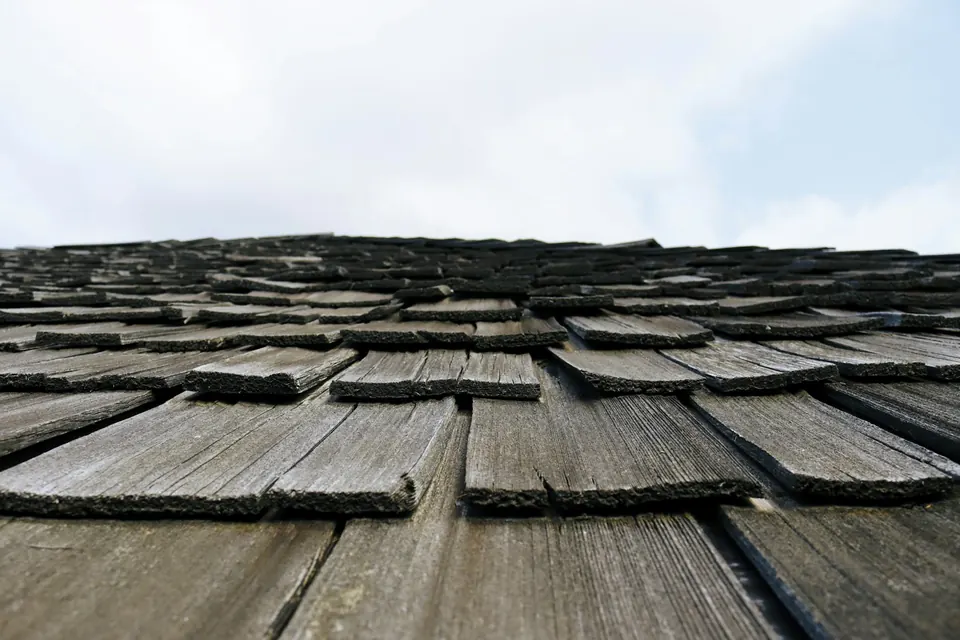 Wood roofing shingles viewed along a slope